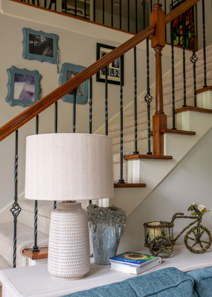 White sideboard behind the couch with two lamps and design accents. Lindsey Putzier Interior Design Aurora Ohio  