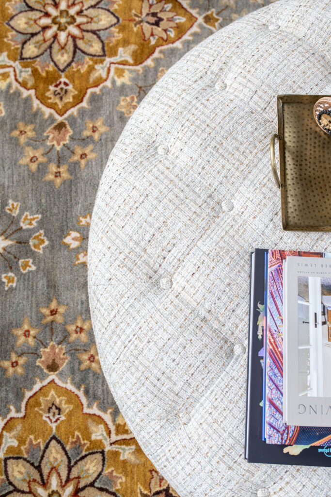Ottoman in the living room with performance fabric, and vintage inspired rug. Lindsey Putzier Interior Design Aurora Ohio  