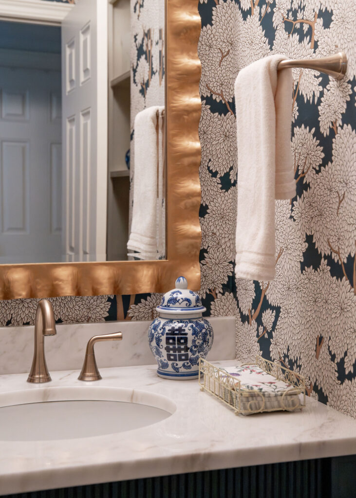 After of the powder room with floral wallpaper, and golden accents. Lindsey Putzier Interior Design Aurora Ohio  