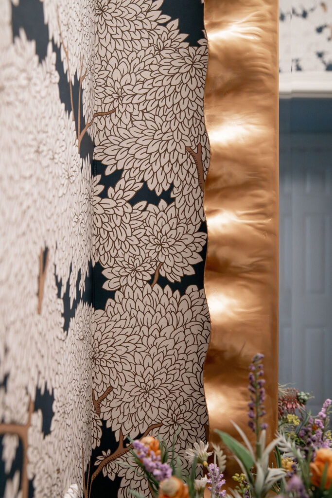 After of the powder room with floral wallpaper, and golden accents. Lindsey Putzier Interior Design Aurora Ohio  