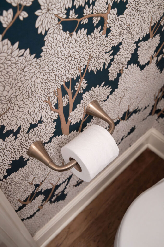 After of the powder room with floral wallpaper, and golden accents. Lindsey Putzier Interior Design Aurora Ohio  
