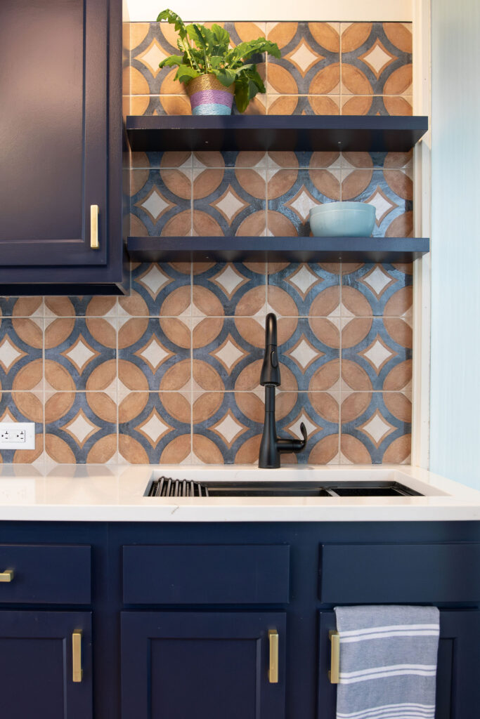 Sink in the breakroom with tile backsplash. Cuyahoga Falls Ohio. Lindsey Putzier interior design