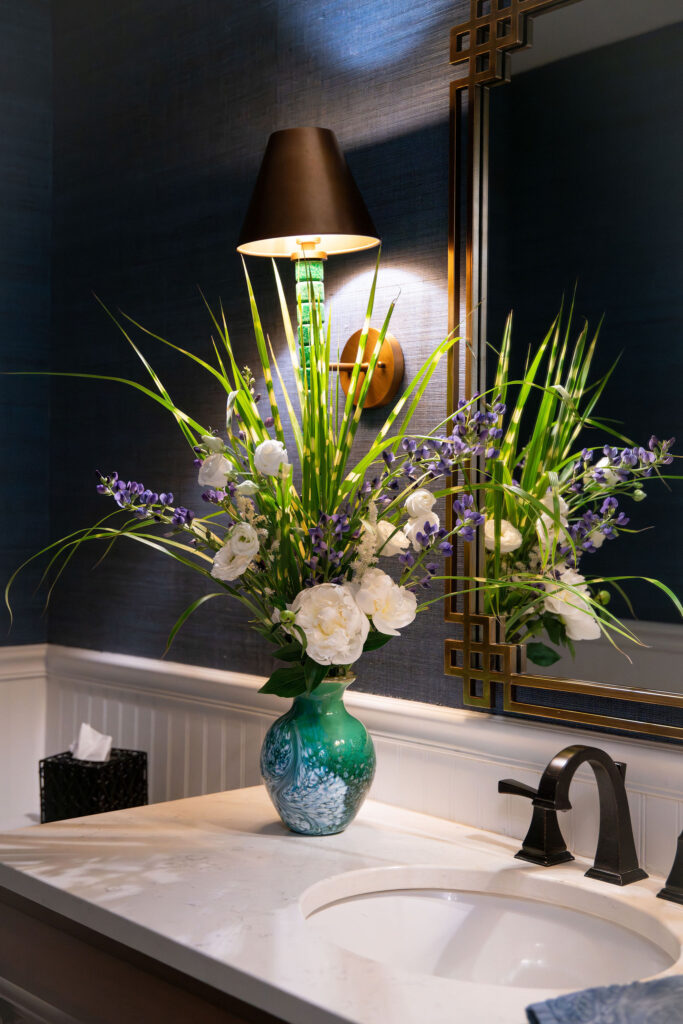 Flower arrangement in the powder room with greenery and purple accents. Hudson Home and Garden Show 2026, interior design, Lindsey Putzier