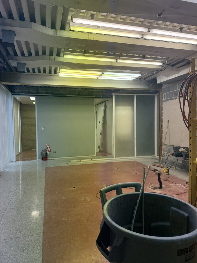Before of the open office space with dated floors and lighting. Cuyahoga Falls Ohio. Lindsey Putzier interior design