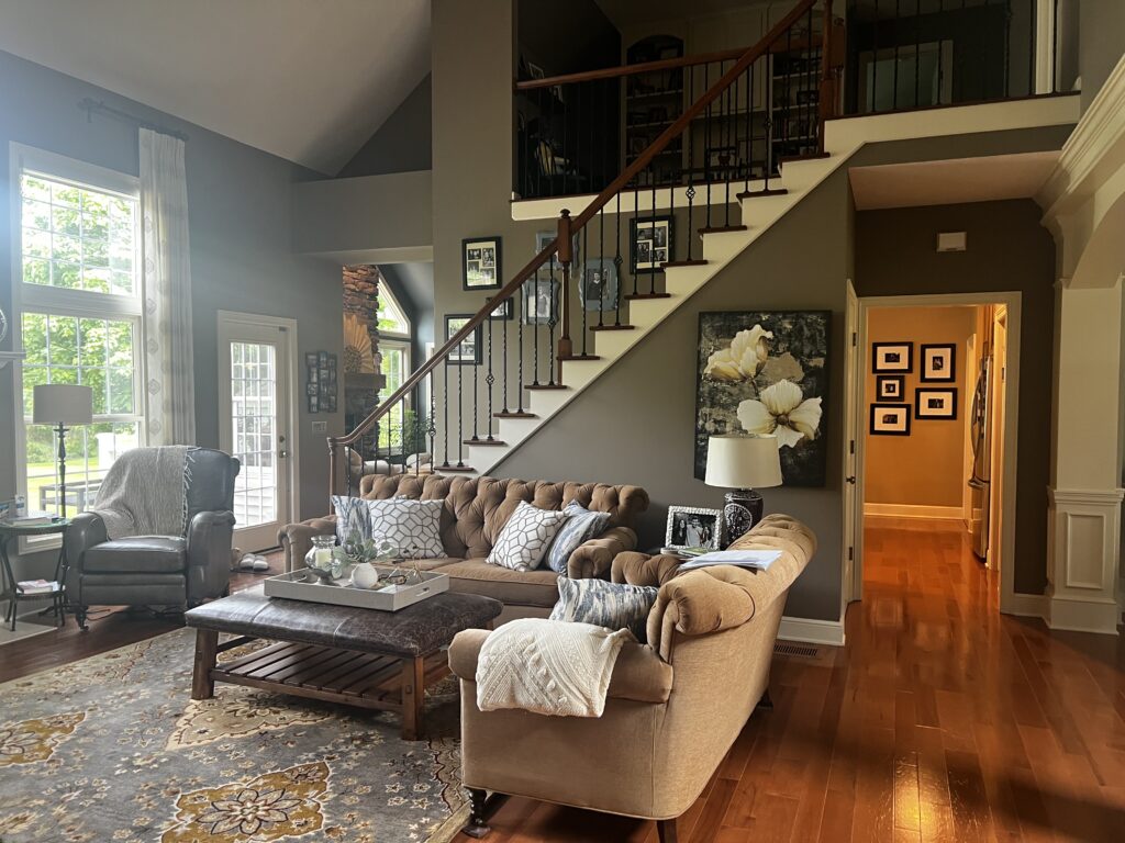 Before of the living room with muted colors and finishes. Lindsey Putzier Interior Design Aurora Ohio 