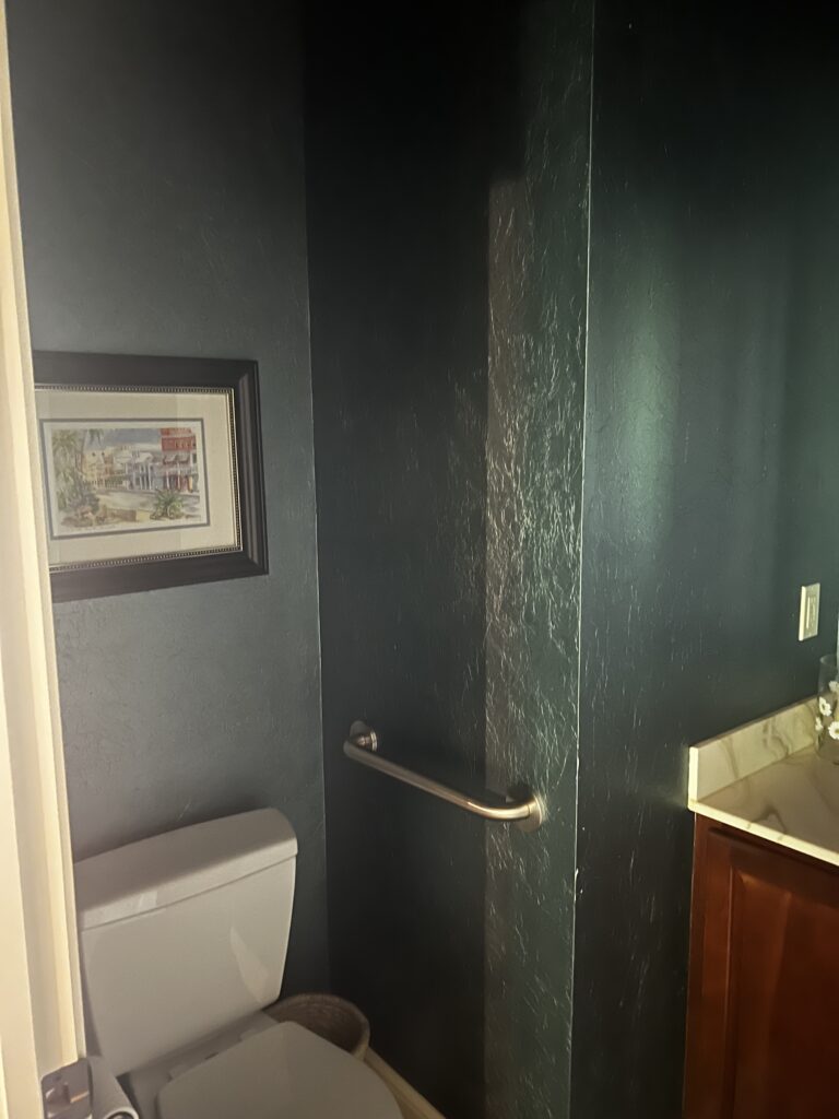 Before of the powder room with dark walls, outdated finishings. Lindsey Putzier Interior Design Aurora Ohio  