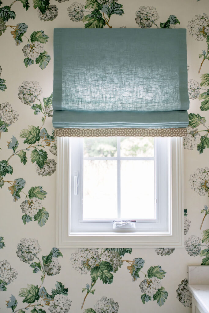 Green roman shade window treatment in a powder room. Hudson Ohio interior design Lindsey Putzier 