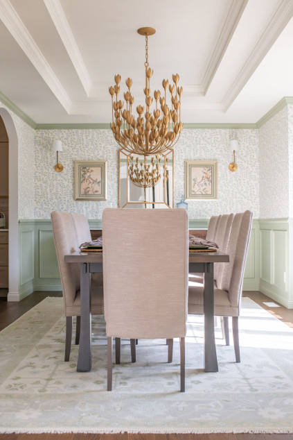 Dining room with two golden flower chandeliers above the table. Hudson Ohio interior design Lindsey Putzier 