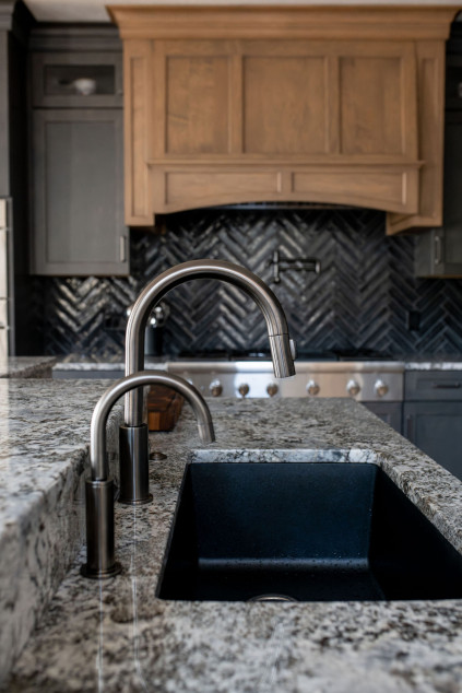 Kitchen with grey faucet and dark fixtures. Hudson Ohio interior design Lindsey Putzier 