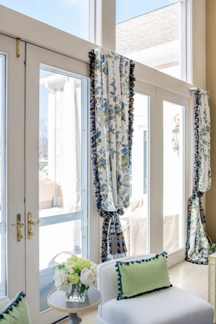 Living room with long luxurious curtains with big tassels. Hudson Ohio interior design Lindsey Putzier 