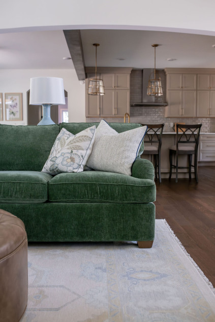 Living room with custom green couch. Lindsey Putzier interior design Hudson Ohio