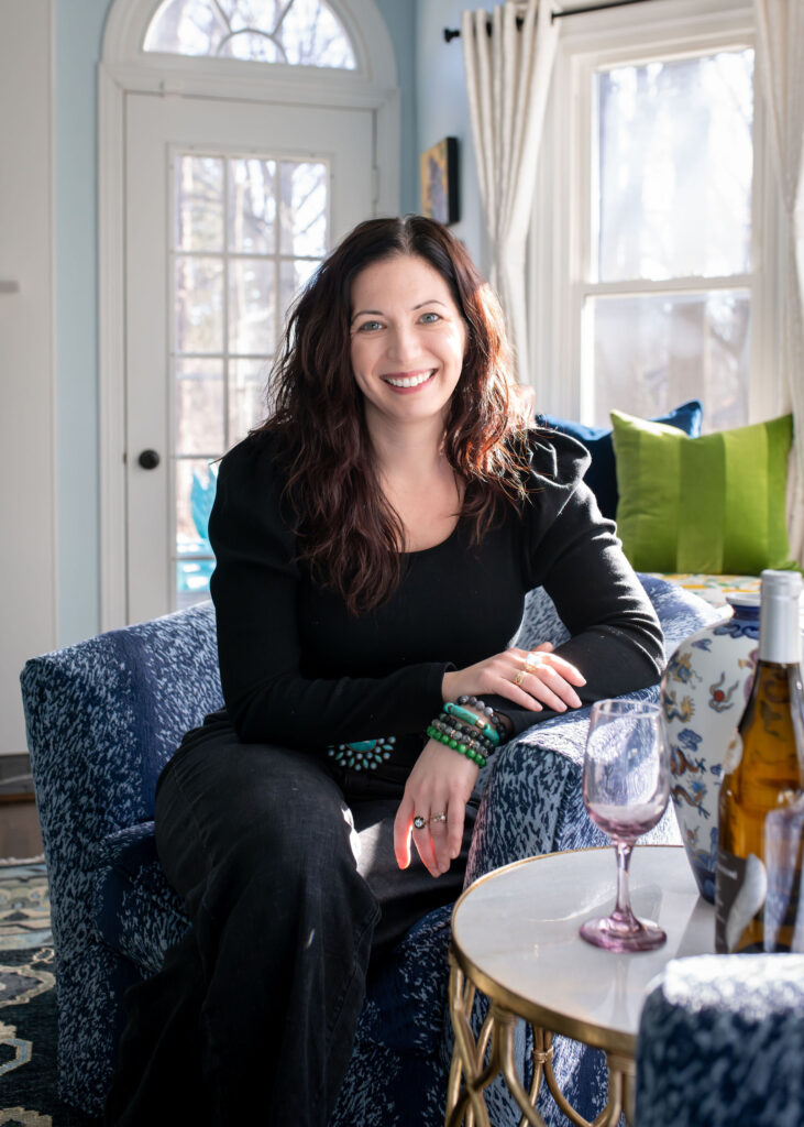 Lindsey Putzier, owner and principal designer, sitting in the living room. interior design, Hudson Ohio
