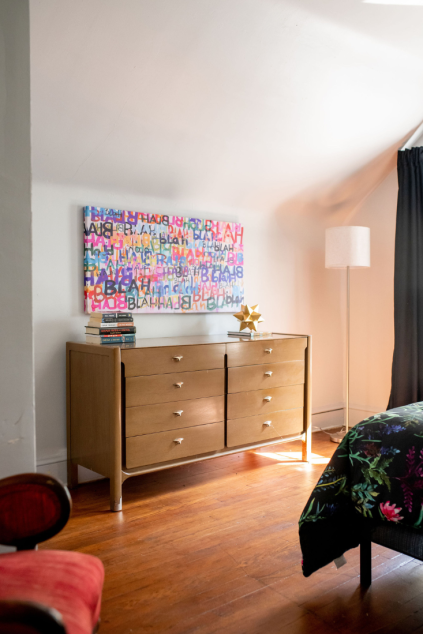Large canvas artwork hanging above the dresser in the bedroom. Lindsey Putzier interior design Hudson Ohio