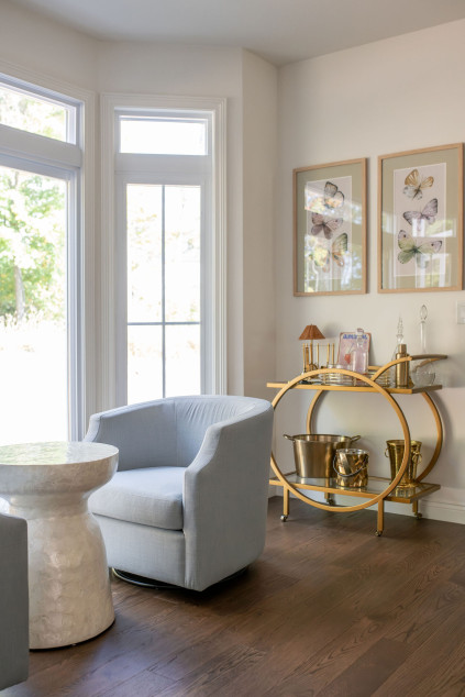 two photos hanging above the bar cart. Lindsey Putzier interior design Hudson Ohio