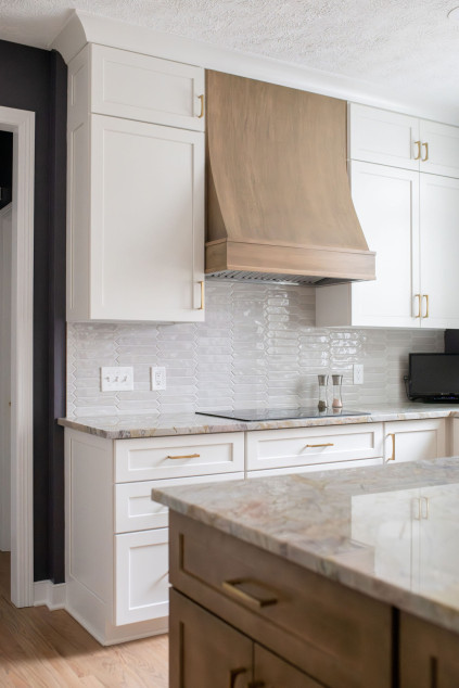 Kitchen with white subway tile backsplash and marble countertops. Lindsey Putzier interior design Hudson Ohio