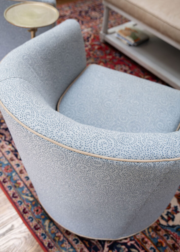 Custom swivel chair in the sunroom with a contrast welt. Hudson Ohio Interior design Lindsey Putzier
