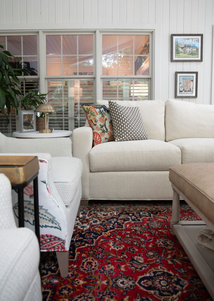 Custom sofa in the sunroom with a bright rug underneath. Hudson Ohio Interior design Lindsey Putzier