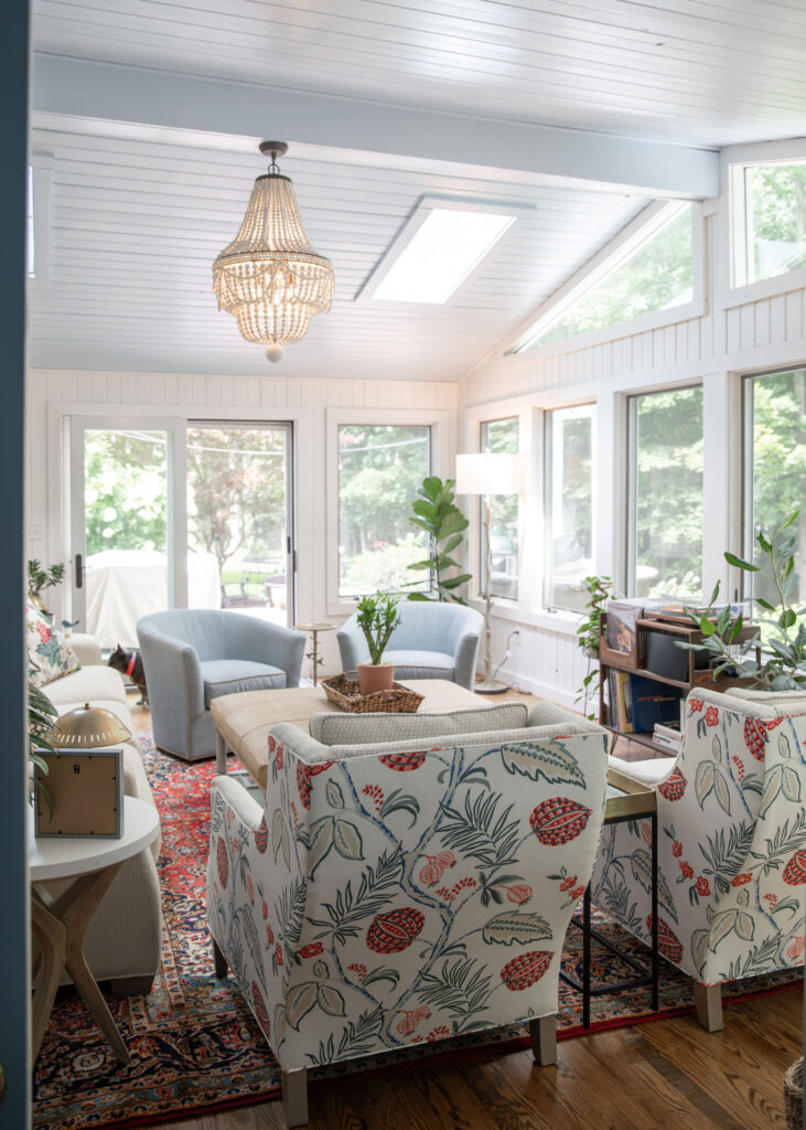 After of the sunroom with a beaded chandelier and custom designed furniture. Hudson Ohio Interior design Lindsey Putzier