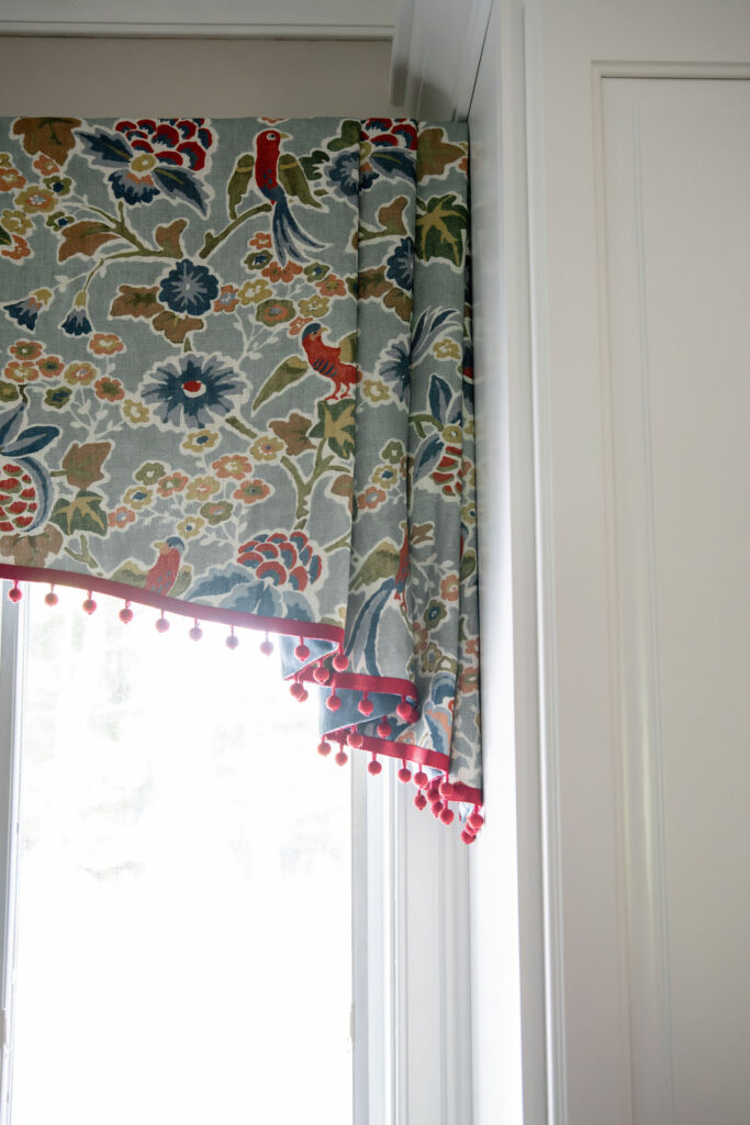 Custom window treatment in the kitchen with fringe edge overtop the sink and marble countertops. Hudson Ohio Interior design Lindsey Putzier