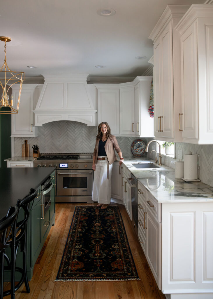 Lindsey Putzier, owner and principal designer standing in the updated kitchen. Hudson Ohio Interior design 