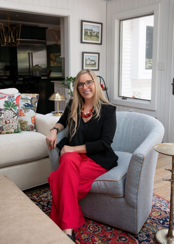 Julianna Watts, senior designer, sitting in the custom swivel chair in the sunroom. Hudson Ohio Interior design Lindsey Putzier