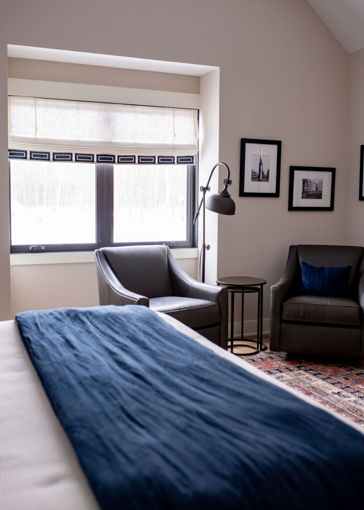 Guest Bedroom with reading chair, and large window. Lindsey Putzier interior design Hudson Ohio