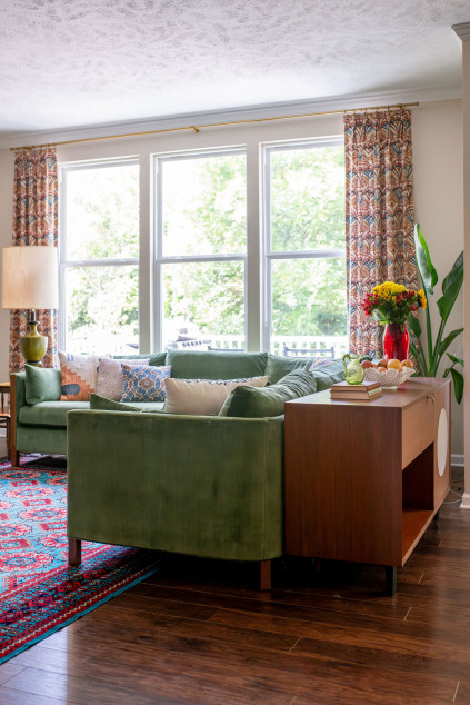 mid century modern living room with colorful sofa, rug, and window treatments. Lindsey Putzier interior design Hudson Ohio