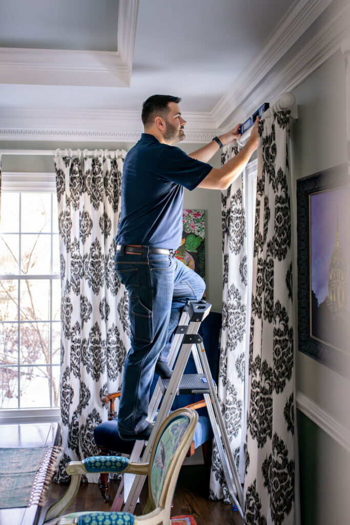 Nathan Putzier, of Premier Transformations, professionally hanging and installing. Lindsey Putzier interior design Hudson Ohio