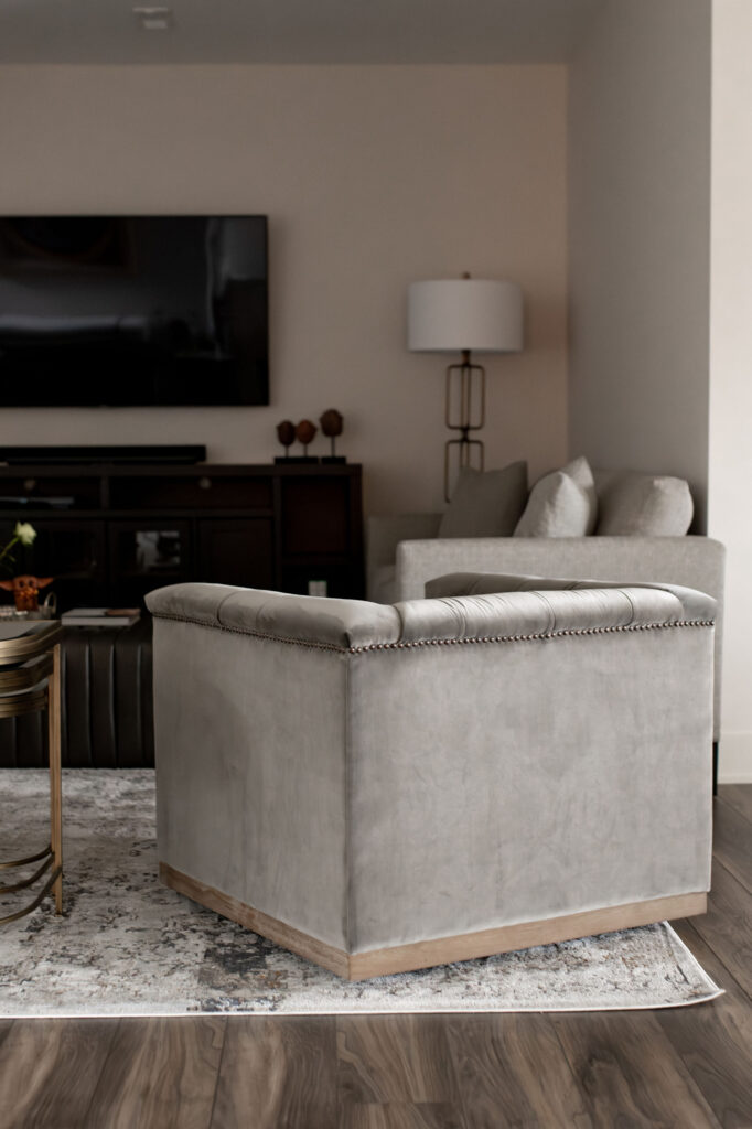 Living room with large gray chair and area rug. Lindsey Putzier interior design Hudson Ohio 