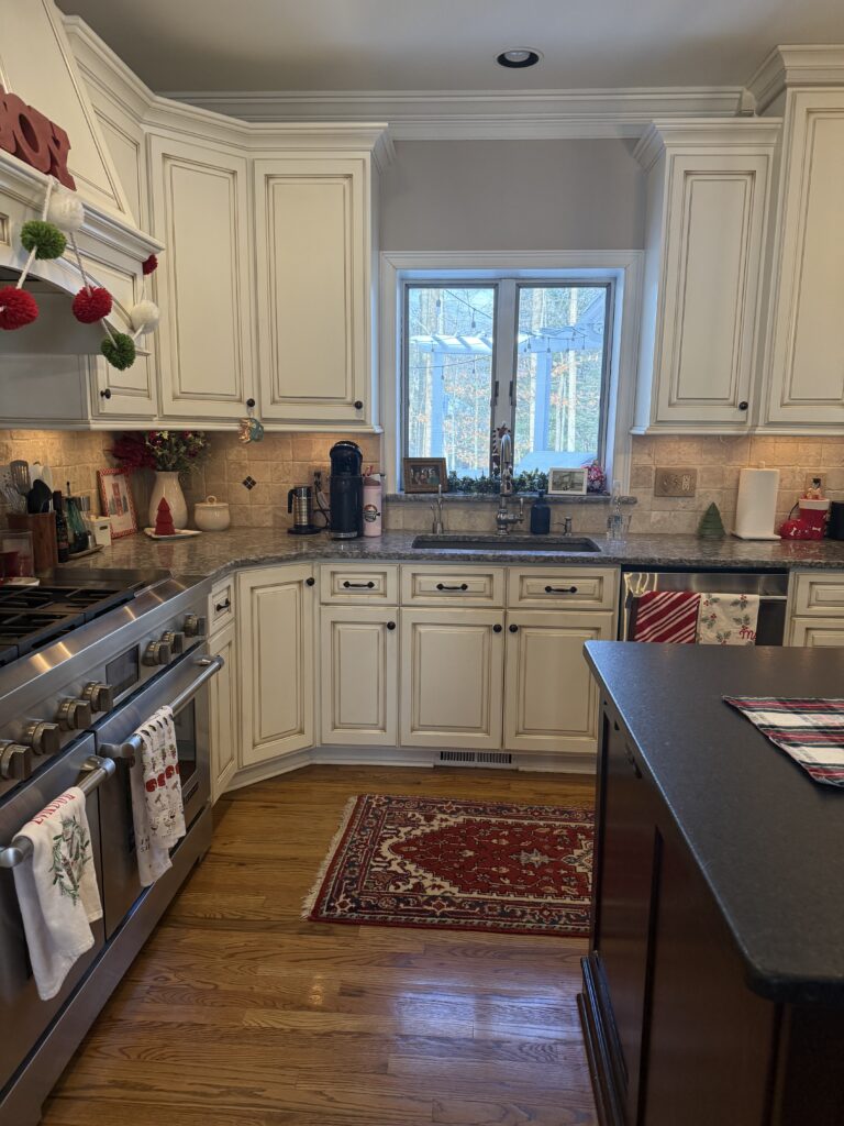 Before of the kitchen with dated countertops and warm backsplash. Lindsey Putzier interior design Hudson Ohio 