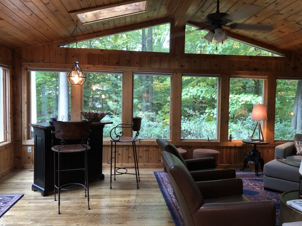 Before of the sunroom with warm wood and warm accents. Hudson Ohio Interior design Lindsey Putzier
